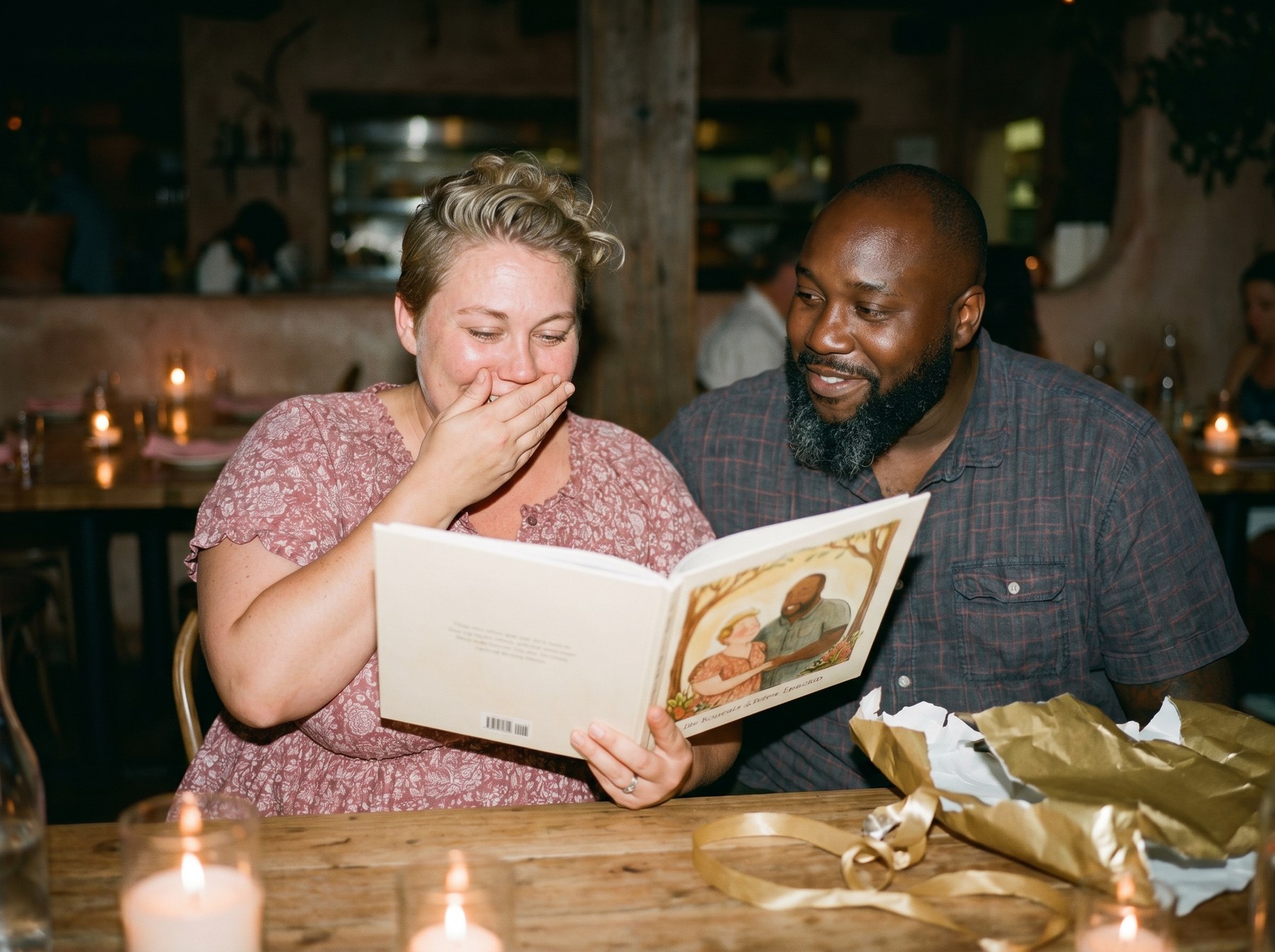 A woman moved to happy tears finding herself and her partner illustrated in an anniversary storybook